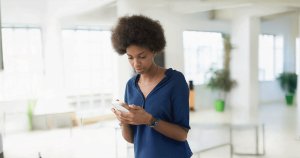 A woman researches pregnancy options and financial support on her phone.