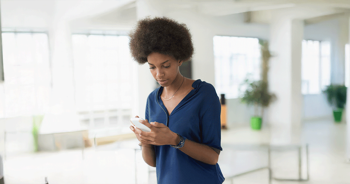 A woman researches pregnancy options and financial support on her phone.